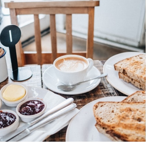 A delicious breakfast served with a cup of cappuccino